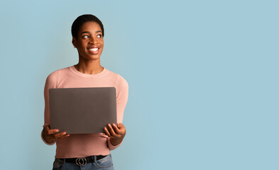 Online Job Opportunities. African Woman With Laptop Computer In Hands Looking Aside
