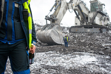 Fototapeta premium Big excavator in coal mine at cloudy day, low angle view