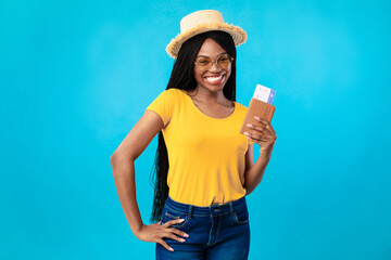 Cheerful Black Lady Tourist Holding Tickets And Passport, Blue Background