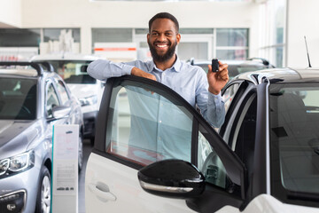 Fototapeta na wymiar Happy Black Man Holding Keys To New Car And Smiling At Camera
