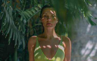 Portrait of a beautiful girl in a tropical jungle