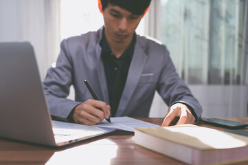 businessman signing documents at work