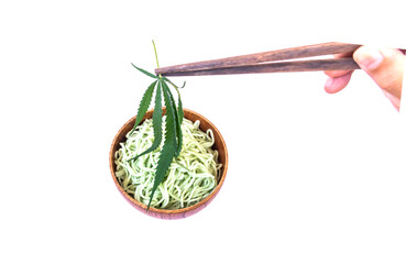 Boiled noodles in a cup, with cannabis leaves.Cannabis-containing foods.