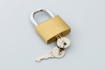 Locked Padlock and keys on the gray backgrou
