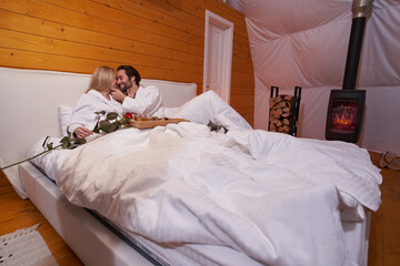 Happy married couple having a romantic evening in bed
