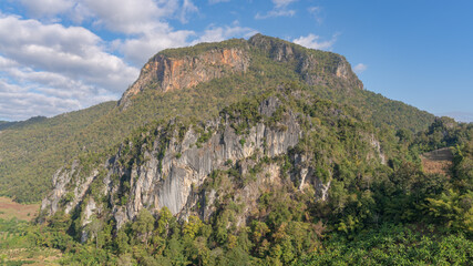 Fototapeta na wymiar Scenic landscape view of karst limestone mountain with cliff and tropical forest in beautiful rural valley, Chiang Dao, Chiang Mai, Thailand