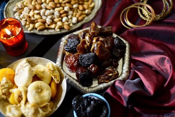 Black Turkish tea in lale with oriental sweets and dried fruits by candlelight 