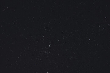 starry night with crisp sky and some clouds with a lot of constellations visible as well as some meteors or satellite trails shot from Tasmania.