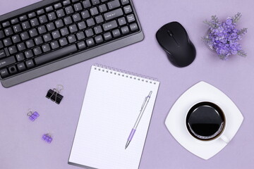 Women neat workplace. Keyboard with computer mouse, blank notebook, stationery, coffee cup on...