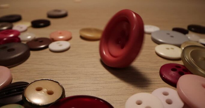 Button for sewing. Button spin on the table. Concept of extreme macro of tailoring and sewing.