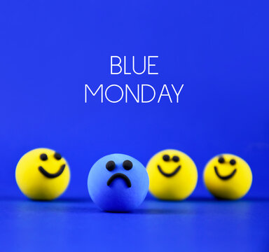 Blue Monday stock images. The most depressing day of the year. Sad day in january images. Blue sad ball and happy yellow balls stock images. Single sad blue smiley among happy yellow ones stock photo