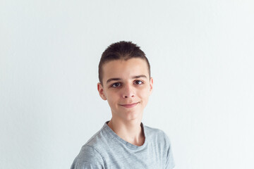 Photo of adorable young happy boy looking at camera.Isolated on the white background