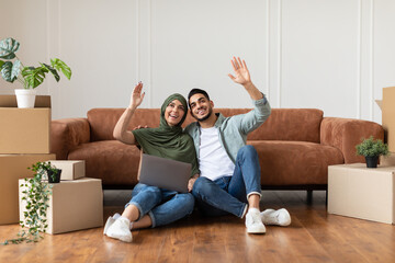 Happy man and woman using laptop after relocation