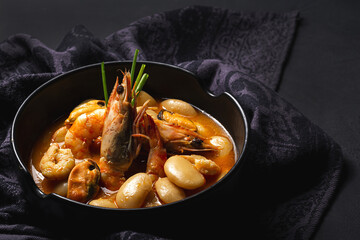 Homemade bean stew with prawns and mussels