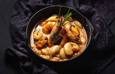Homemade bean stew with prawns and mussels