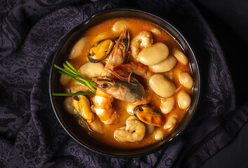 Homemade bean stew with prawns and mussels