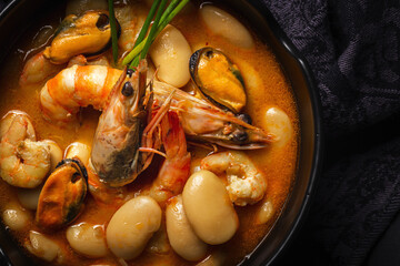 Homemade bean stew with prawns and mussels