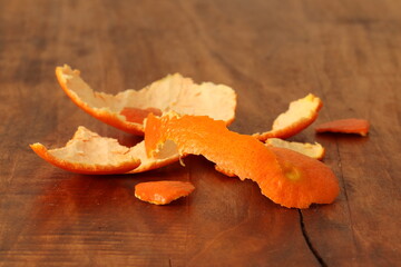 Tangerine skin on a wooden background. Mandarin contains beneficial elements and minerals. 