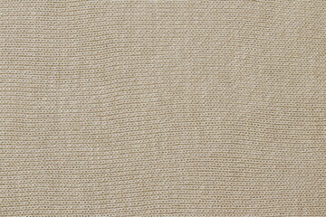 Fototapeta na wymiar Light texture of sweater fabric. The fabric of the sweater is made of cotton. 