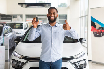 Black Man Standing Near New Car, Holding Key And Showing Thumb Up