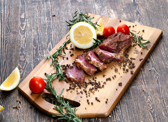 dried and spiced meat sliced on a wooden board