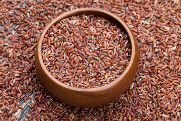 raw uncooked red rice, unpeeled