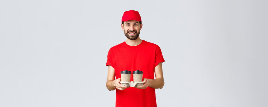 Food Delivery, Quarantine, Stay Home And Order Online Concept. Smiling Courier In Red Cap And T-shirt Bring Coffee To Clients. Employee Handing Beverege Via Drive Through Window