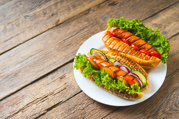 Pair of Grilled Hot Dogs on a plate.