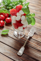 Mini mozzarella with tomatoes and green basil.