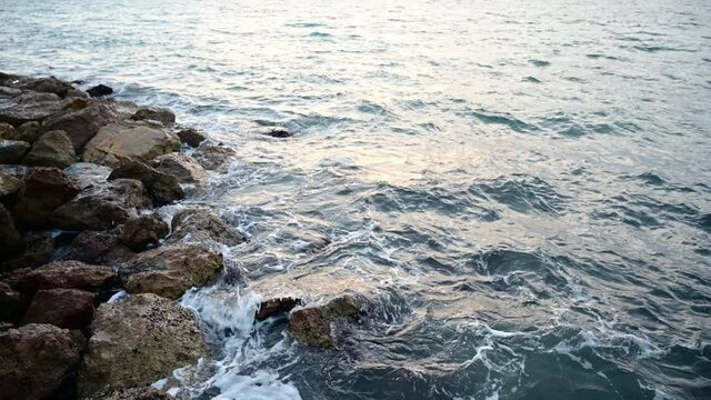 Video of sea waves breaking on the rocky shore at the beach of Salou, Tarragona