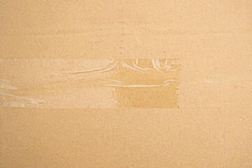 Brown paper box or Corrugated cardboard sheet with tape texture 