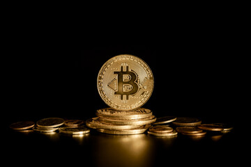Bitcoin BTC Cryptocurrency Coins on gold money coin with black background