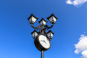 Fototapeta na wymiar Street lamp with clock, close up 
