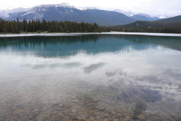 Beautiful blue clear lake Anette in Jasper. Wonderful road trip through Banff and Jasper national park in British Columbia, Canada. An amazing day in Vancouver. What a beautiful nature in Canada.
