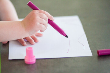 child drawing with chalk