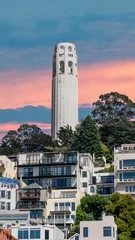 Poster San Francisco, California, USA - August 2019: Coit Tower during sunset, pink skies. Coit Tower in the Telegraph Hill neighborhood of San Francisco, offering panoramic views over the city and the bay. © CanYalicn