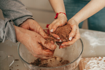 CLose-up photo of woman man hands, Happy couple baking cookies on cozy kitchen at home, mixing dough, mom and dad in making cookies, teamwork