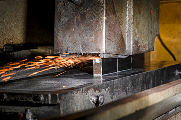 Sparks from the abrasive wheel while flat grinding metal.