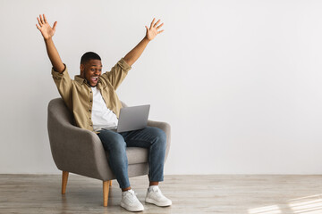 African Guy With Laptop Raising Hands In Joy, Gray Background