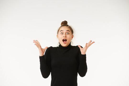 The girl in black clothes on a white background depicts the emotion
