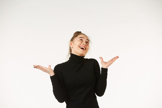The girl in black clothes on a white background depicts the emotion