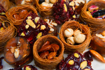 Dried fruits baklava and Turkish delight with pistachios and nuts, close-up view .