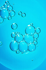 Close up macro Aloe vera gel serum cosmetic texture blue background with bubbles. Cruelty free. Lemongrass gel skincare product. antibacterial liquid with aloe vera, moisturizing.