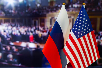 The US flag, Russian flag with copy space for text. Flag of USA, flag of Russia. The United States of America and the Russian Federation confrontation. Russia's invasion of Ukraine