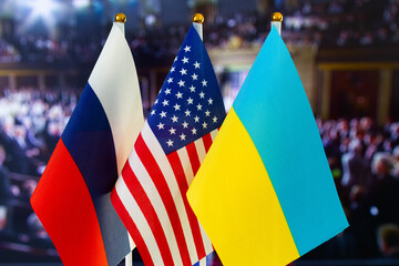 The US flag, Russian flag, Ukraine flag. Flag of USA, flag of Russia, flag of Ukraine. The United States of America and the Russian Federation confrontation. Russia's invasion of Ukraine