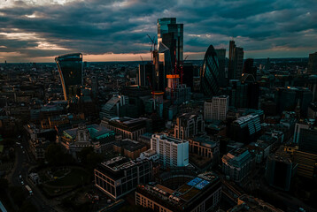 Obraz premium Aerial view of The bank district of central London with famous skyscrapers and other landmarks at sunset.