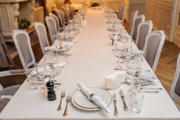 photo of a table in a restaurant with plates, wine glasses, knife and fork..