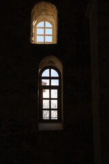 Ancient windows, vertical photo of two windows showing outside of building.