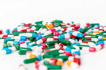 Colorful antibiotic drug capsules pill on white background. Global healthcare and antibiotic resistance concept.