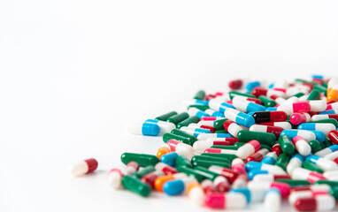 Colorful antibiotic drug capsules pill on white background. Global healthcare and antibiotic resistance concept.